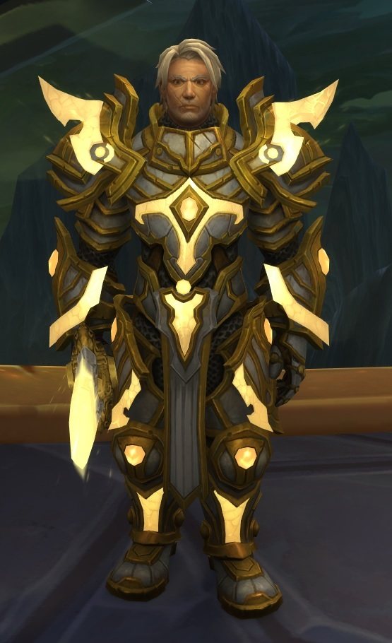 Full-length view of High Exarch Turalyon in white and gold plate, a sword of Light in one hand, mountains behind him.